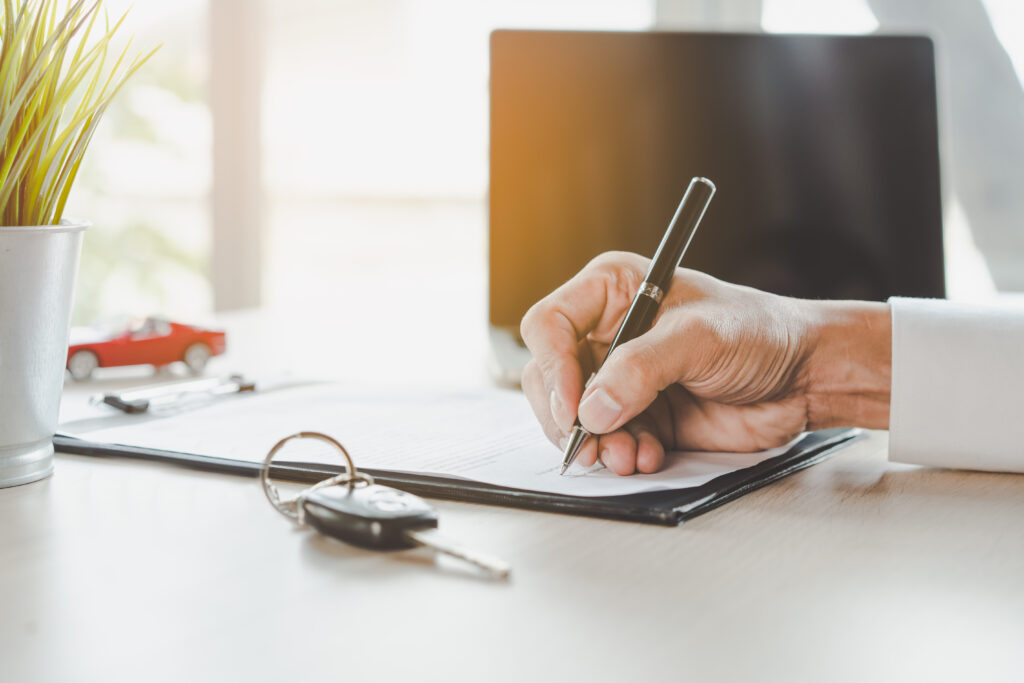 Close,Up,Shots,Hands,Of,Client,Signing,Car,Lease,Form.